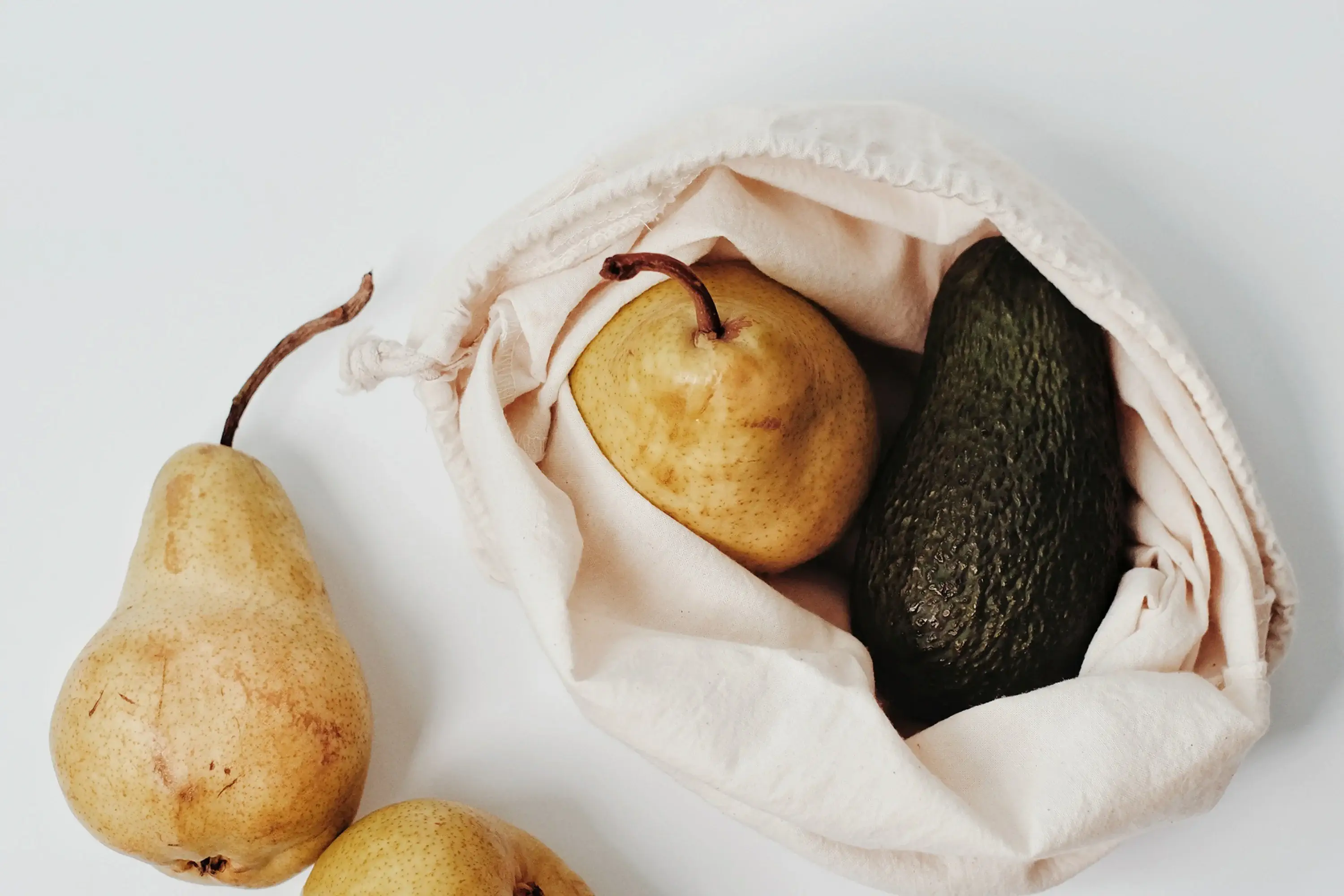 pears and avocado in a canvas bag